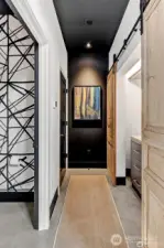 Hallway to 1/2 bath,  & clothes + storage closet