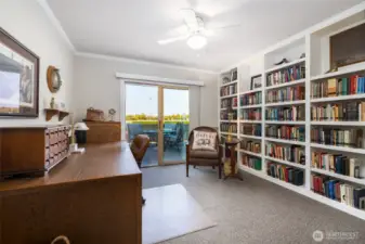 Bedroom 3 with access to back deck, built in book shelves.