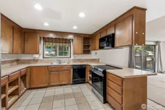 Kitchen view, nice tile flooring and new range/oven, family room to your right.
