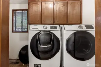 Utility room with included washer and dryer & great storage.