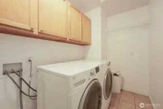 Large laundry room with drying rack, and space for laundry hamper!