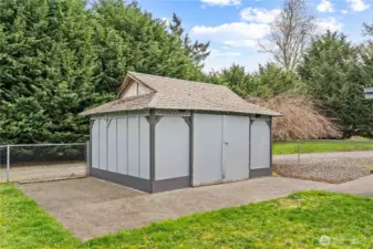 Large shed in yard for mower and equipment