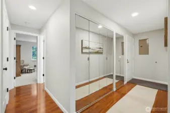 hallway to front door and hallway to bedrooms. washer and dryer are in the glass door closets