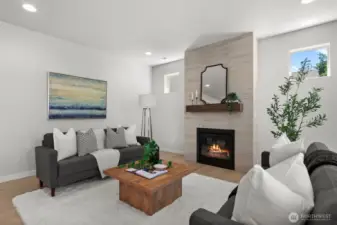 A floor to ceiling tiled wall surrounding a gas fireplace adds a beautiful focal point to the room.