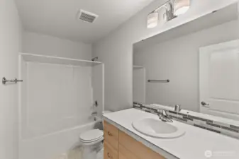 Located between the bedrooms on the upper level, the full bathroom offers convenient and easy shared access.