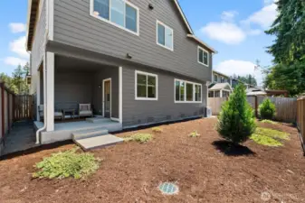 A large level backyard is fully enclosed with room for you to plant your dream garden or design a custom outdoor space.