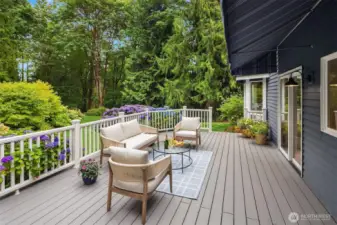 Enjoy serene outdoor living on a spacious back deck nestled in a peaceful, private setting.
