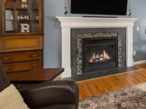 Uniquely beautiful custom river rock trimmed gas fireplace.