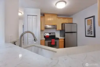 Kitchen includes all appliances including a newer garbage disposal, quartz countertops, newer sink and faucet all installed in 2020
