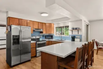 Kitchen with eat-in bar, Corian counters, stainless appliances