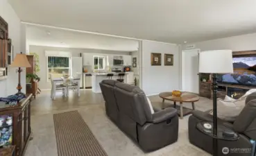 Living, dining, and kitchen areas, are seamlessly connected, creating a comfortable and functional layout for everyday living.