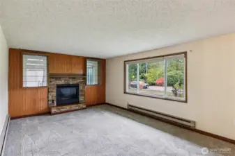 Living room w/ gas fireplace and large window