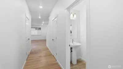 Warm wood-tone floors and fresh white walls create an inviting first impression.