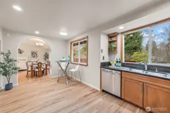 Elegant archway connects the kitchen to the dining area.