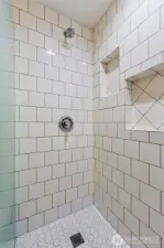 This bathroom boasts tile floor to ceiling.