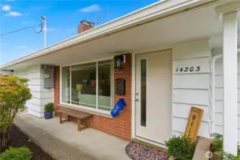 The approach to the front door has a convenient overhang to protect in any weather. Easy no-step entry to the home.
