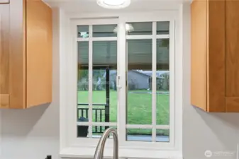 The kitchen window over the sink offers a view to the spacious, peaceful backyard.