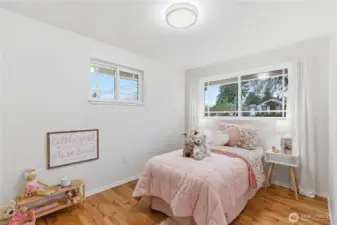 This darling corner bedroom looks out over the front yard. It also has windows on two sides to enjoy those summer breezes.