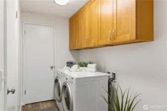Near the interior garage entrance is this laundry area. The brand new cupboards above and the closet nearby, offer fantastic storage space.