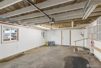 The door in the back accesses the backyard of the home. Tons of room here to make it your dream garage!