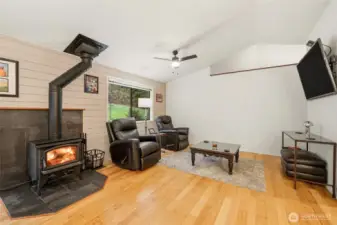 Front room featuring a cozy wood-burning stove, adding warmth and character to this inviting living space.