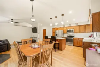 Dining area flowing into the kitchen, highlighted by designer lighting and an open layout ideal for everyday living and entertaining.