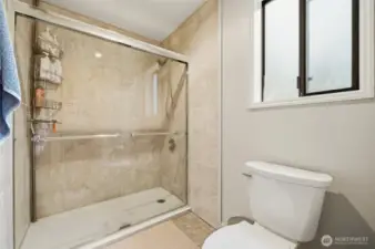 Walk-in tiled shower with clean finishes, adding comfort and style to the primary bath.