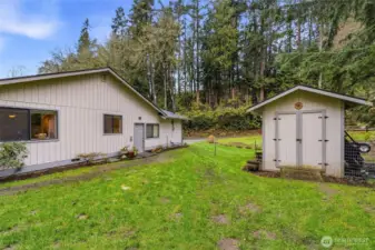 Convenient man door access to the garage and nearby storage shed for added utility.