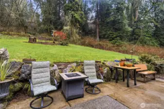 Patio area with space for outdoor seating, ideal for enjoying the private backyard setting.