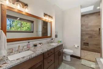 In the master bath, benefit from the soaking tub, views and walk-in stone shower with double heads.