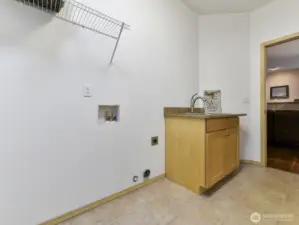Utility room has sink and storage area.