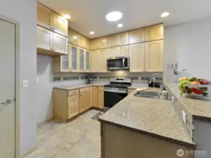 Granite countertops. and Upgraded to ceiling cabinets. Pantry,  Stainless sink. Gas stainless stove. Tile Backsplash.