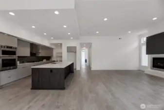 View from the dining room of the kitchen, great room and the hallway to the entry