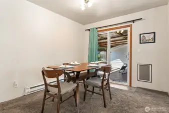 Dining area w/ slider to the back deck.