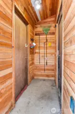 Storage shed to the left and garage access to the right.