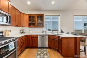 Maple cabinetry with glass door accents are just one of the upgraded features this home offers.