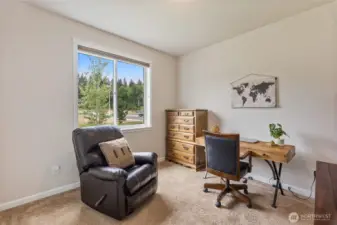 This multi=purpose room can be used as an office or a third bedroom.  Up-down shades clothe a window that looks out onto the resource parcel.