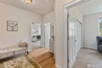 The office/3rd bedroom is to the right.  The primary bedroom is through the door on the left and the laundry room is in between.