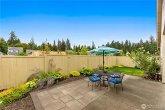 The ipatio has been increased in size with attractive stone work that maximizes outdoor dining/BBQ area and decreases the lawn maintenance.