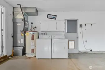 Garage with Laundry and Door to Backyard