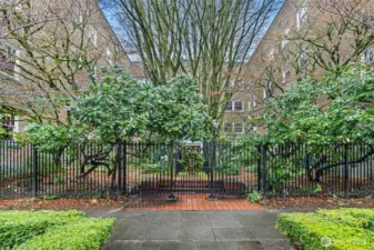 Set on a tree-lined street, the gated brick courtyard and mature landscaping offer a peaceful welcome to the timeless charm of Garden Court.