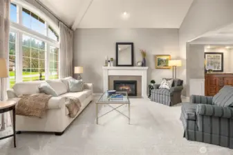 A welcoming formal living room w/ gas fireplace awaits just beyond the grand foyer