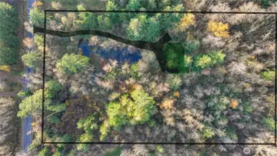 Property aerial with proposed driveway and conceptual boundary lines for reference