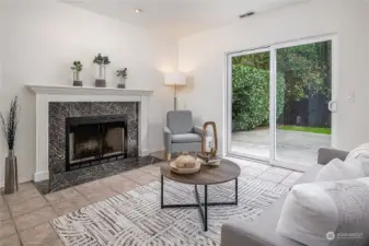 The family room on the lower level with a wood-burning fireplace and sliders to the patio and yard.