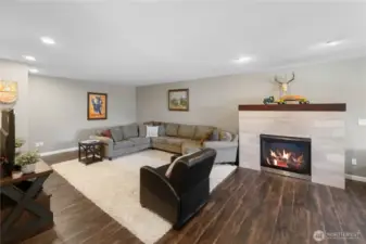 Rec room on the upper floor with a gas fireplace.