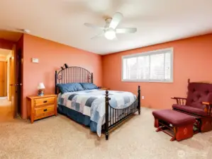 Generous primary suite located near peaceful backyard oasis.