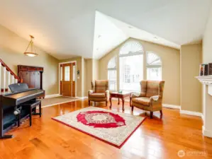 Open vaulted living room and entry.