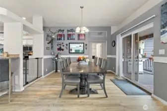 Light, bright, beautiful open floor plan dining room with sliding glass doors to front deck