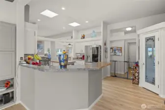 Chef's kitchen with granite countertops, stainless appliances, skylights, and large pantry