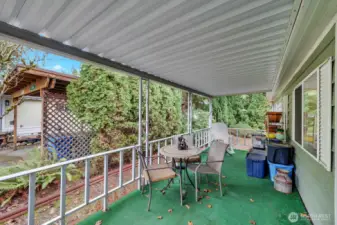 Covered front porch is full length of the side of home. Room for outdoor furniture, BBQ or ?  You can sit out here and enjoy the sounds of nature. Peace and quiet! Enjoy morning coffee -tea and just take in your surroundings.